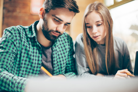 Young man and woman are working on a new projectの写真素材