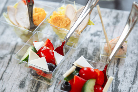 Fresh salad with cheese and tomato in a glass. Catering