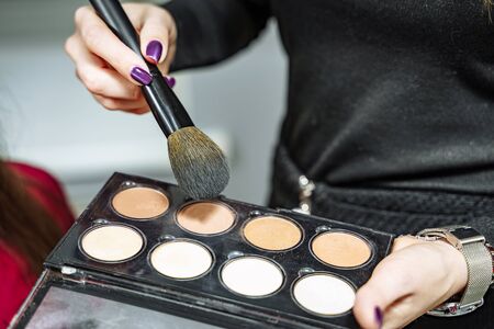 Female makeup artist with cosmetics at work close-up.の写真素材