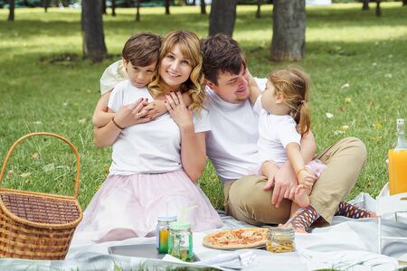 Portrait of a happy family on a picnic on a sunny summer day.の写真素材
