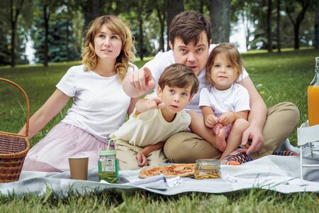 Portrait of a happy family on a picnic on a sunny summer day.の写真素材