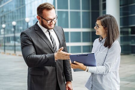 Modern business. Business team brainstorming. Successful business man and young woman communicating.の写真素材