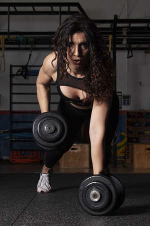 woman in the gym lifted weightsの写真素材