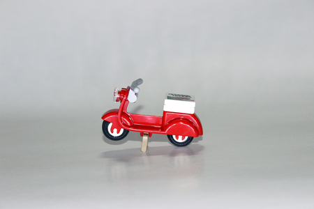 Red toy scooter isolated on white backgroundの写真素材