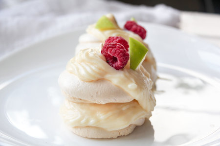 Pavlova meringue cake with custard and fresh berriesの写真素材