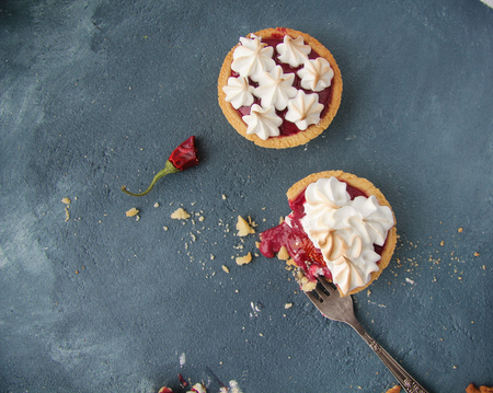 sand tarts with raspberry curd, chili and merengue on a concrete backgroundの写真素材