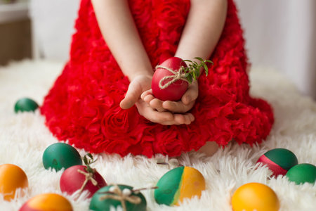 the girls hands hold decorated Easter eggs
