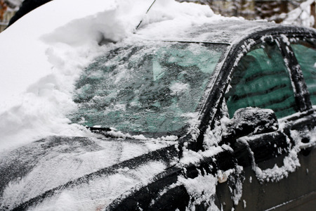 Winter. Snow-covered car. Part of the machine cleared of snow.の写真素材