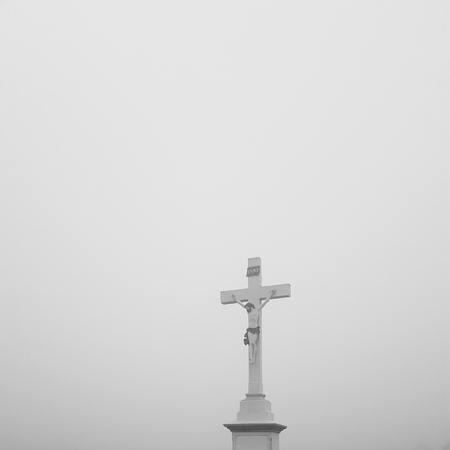 Jesus on a cross lost in the fogの写真素材