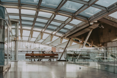 3 people siting at the modern railway station, Lisbon, Portugalのeditorial素材