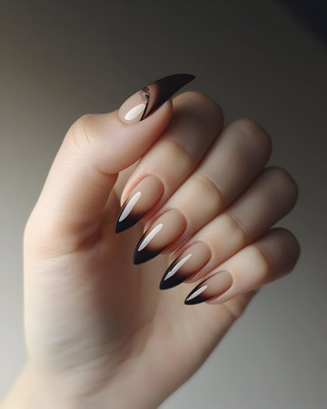 Female hand with black nail design. Glitter nail polish manicure.の素材