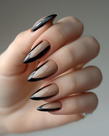 Female hand with black nail design. Nail polish manicure.の素材