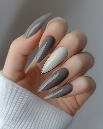 Female hand with gray nail design. Glitter silver nail polish manicure.の素材