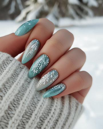 Female hand with blue nail design. Glitter nail polish manicure. Female hand with blue nail polish on winter background.の素材