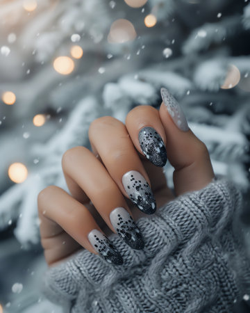 Female hand with gray nail design. Glitter silver nail polish manicure. Woman hand with silver nail polish.の素材