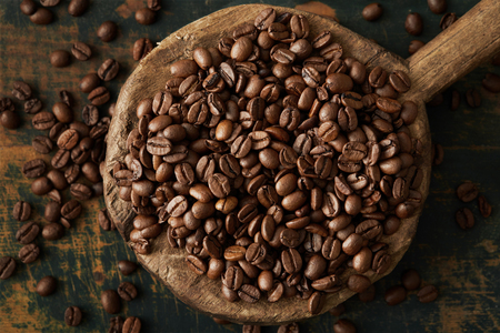 Coffee beans in a wooden cupの写真素材