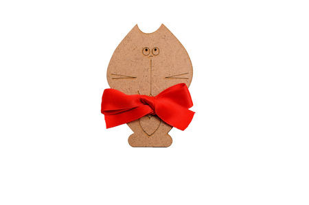 wooden cat with a red bow around his neck isolated on white backgroundの写真素材