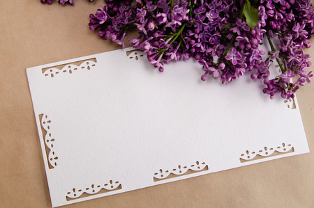 Bouquet of lilacs on a wooden table with an inscription cardの写真素材