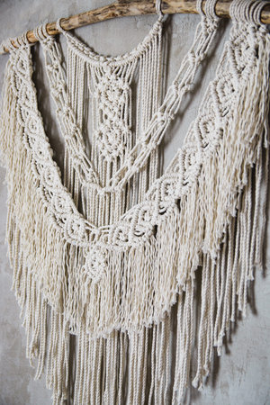 Wall panel in the style of Boho made of cotton threads in natural color using the macrame technique for home decor and wedding decoration. Beautiful boho macrame wall panel will add a cozy atmosphere and charm to any space in your homeの写真素材
