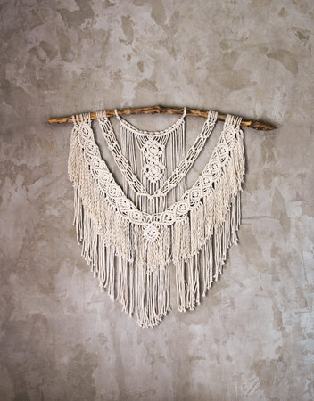 Wall panel in the style of Boho made of cotton threads in natural color using the macrame technique...