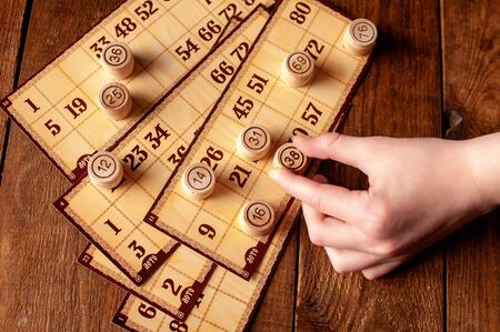 family vintage interesting lotto bingo game, hand holds a keg with a numberの写真素材