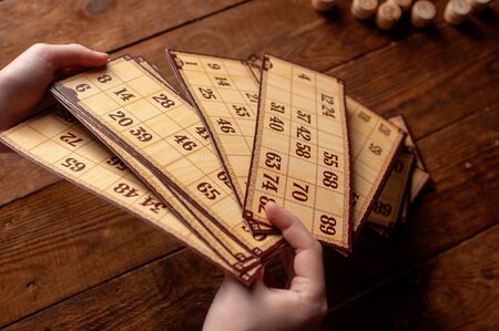 family vintage interesting lotto bingo game, hand holds a keg with a numberの写真素材