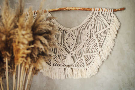 Beautiful boho macrame wall panel will add a cozy atmosphere and charm to any space in your homeの写真素材