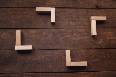 background wooden brown there are laid out wooden rectangles, arranged in a certain order in the...