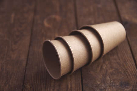 ecological kraft paper cups for coffee and tea dark brown on the tableの写真素材