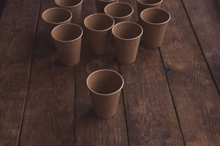 ecological kraft paper cups for coffee and tea dark brown on the tableの写真素材