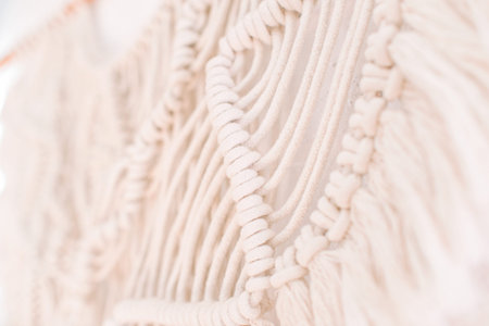 handmade macrame pattern a fragment of a wall panel in the boho style of beige cotton threads of...