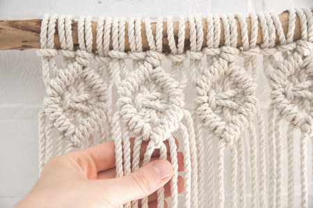 Boho wall mural made of natural color cotton threads using macrame technique for home and wedding...