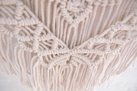 Close-up of hand made macrame texture pattern. Handmade macrame 100 cotton wall decoration with...