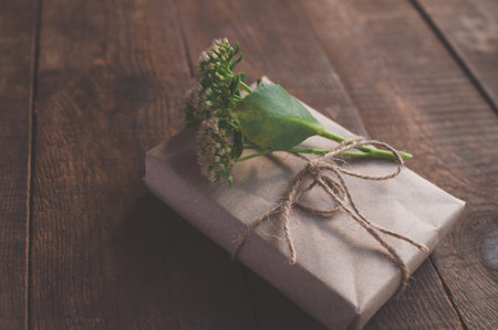 gift wrapped in wrapping kraft paper, decorated with flowersの写真素材