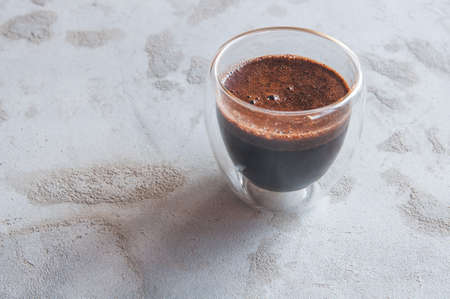 coffee in a glass with double walls on a concrete backgroundの写真素材