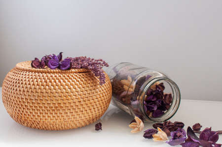 wicker rattan box craft round top with dried flowers and lavender on a white backgroundの写真素材