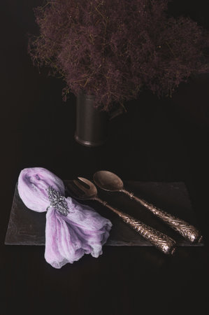 Bouquet of lavender on a black board made of raw stone with a napkin on a dark backgroundの写真素材