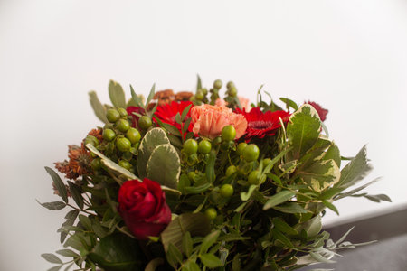 Gift flower arrangement close-up, a bouquet of mixed flowers in a roomの写真素材