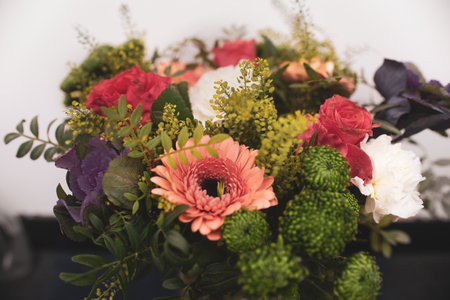 Beautiful flower arrangement close-up, a bouquet of mixed flowers from carnations in gerberas in a flower shopの写真素材