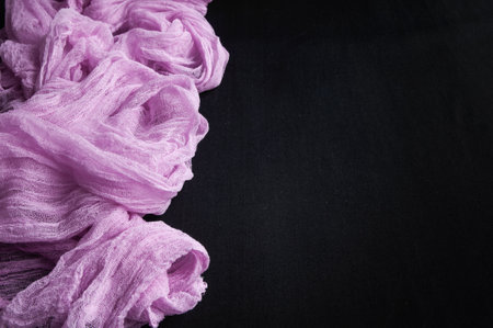 Lilac gauze fabric on a black background. Place for text.の写真素材