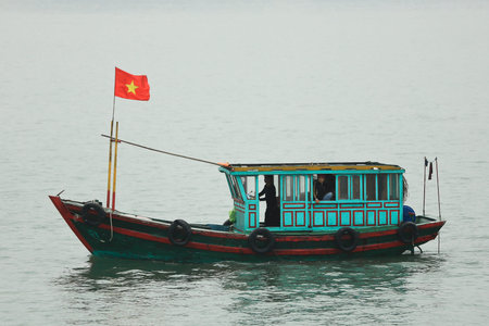 Halong Bay, Vietnam - April 10 2014  Fishing boat in Halong Bay used predominantly to supply the local floating villages  Halong Bay is a UNESCO World Heritage Site and it is one of the prime travel destinations in Vietnam のeditorial素材