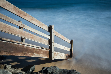Wooden staircase down to the beach at sunriseの写真素材
