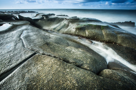 Long exposure sunrise over looking oceanの写真素材