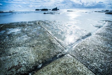Long exposure sunrise over looking oceanの写真素材