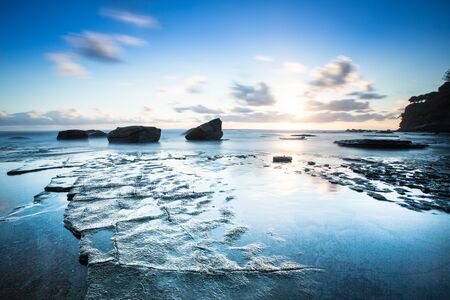 Long exposure sunrise over looking oceanの写真素材