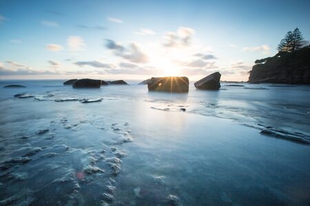 Long exposure sunrise over looking oceanの写真素材