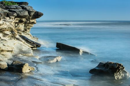 Long exposure sunrise over looking oceanの写真素材