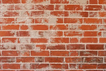 A red rough brick wall with textured grey rendering and groutの写真素材