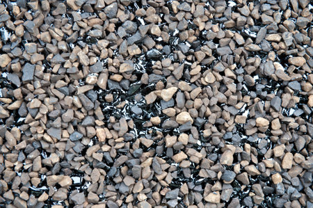 FRESHLY LAID BITUMEN ROAD TARMAC WITH BLUE METAL STONES