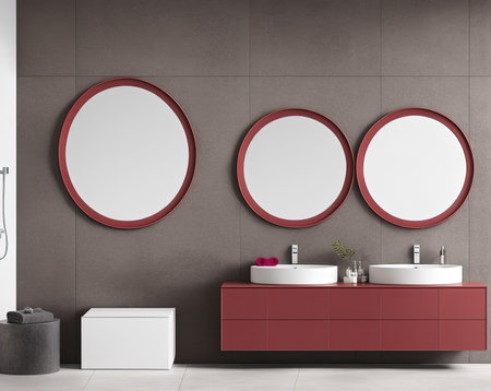Interior of modern bathroom with gray walls, tiled floor, comfortable red double sink standing on red countertop with round mirrors. 3d renderingの写真素材